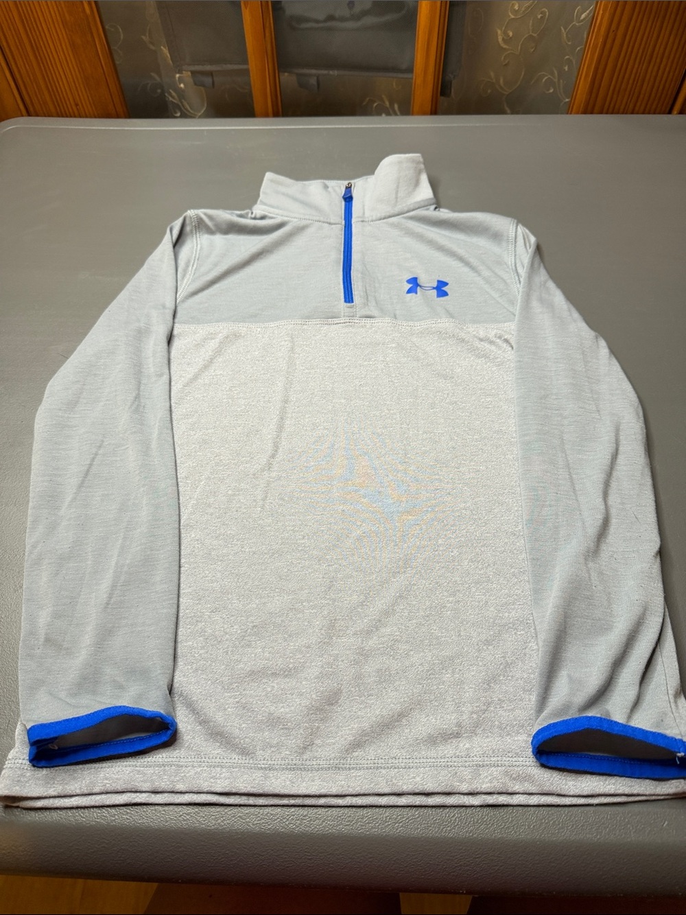 Kid’s Under Armour Light Gray Pullover with Royal Blue Trim. Size: medium